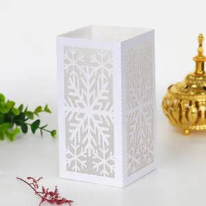White laser cut snowflake paper lampshade for Christmas home decor and holiday ambiance.