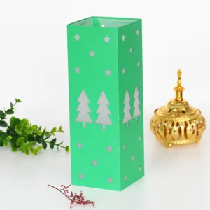 Green laser-cut paper Christmas tree lantern lampshade for holiday party decor and home night lighting.