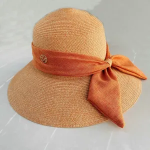 Chapeau de paille femme été anti-uv avec beau ruban nœud et logo métal pour la plage.