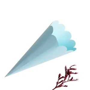 Light blue scalloped paper confetti cone detail shot, perfect for wedding party decor.