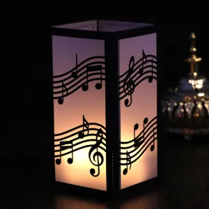 Handcrafted black and white laser cut musical note paper lantern night light for decor.