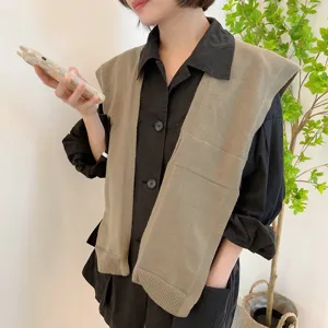 Close-up of stylish knit shawl vest detail, pairing nicely over a classic black shirt.