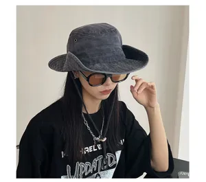 Detailed view of the vintage washed grey bucket hat with wide brim and chin strap style.