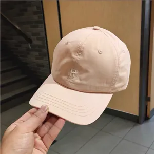 Detailed view of the pink baseball cap with R letter embroidery, casual sunshade style.