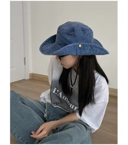 Detail view of vintage blue denim bucket cowboy hat, showcasing casual outdoor style.