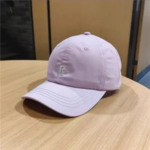 Stylish light purple casual baseball cap featuring delicate front letter embroidery details.