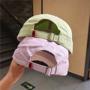 Adjustable strap baseball cap detail showing breathable fabric and metal buckle design.