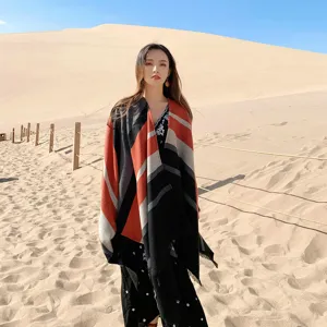 Ethnic style split shawl detail with geometric stripes, warm cape in scenic view.
