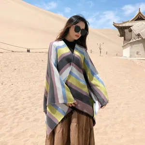 Detailed view of ethnic style multi-color striped split poncho shawl in outdoor desert scene.