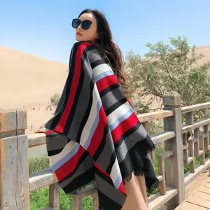 Cozy autumn winter split shawl poncho featuring stylish striped design, ideal travel accessory.