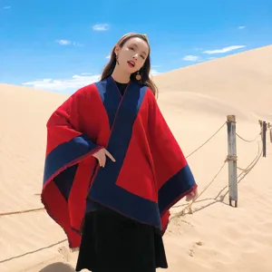 Outdoor desert scene detail shot of women ethnic style color blocked warm winter poncho cloak.