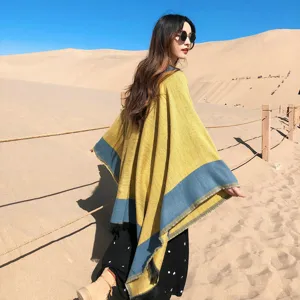 Detailed view of the stylish winter women's color-blocked poncho shawl, cozy and warm.