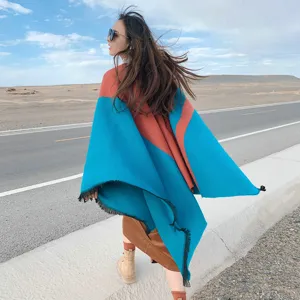 Detail view of women's ethnic cashmere-feel color-blocked fringe cape shawl for autumn and winter.