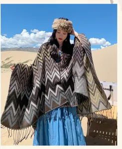 Detailed view of the bohemian chevron knit shawl, thick warm cashmere-feel texture with chic fringe.