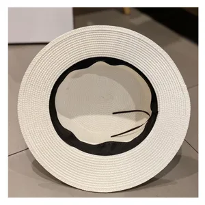 Details of the white straw sun hat with black ribbon for women summer beach vacation.