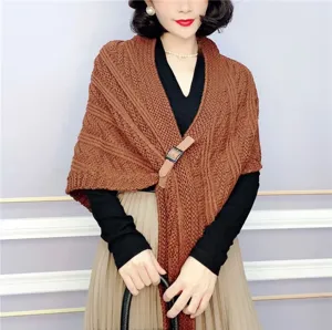 Detailed view of the women's brown knitted shawl cape with leather buckle and stylish design.