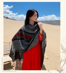 Detail view of the bohemian style striped cashmere-feel tassel cape shawl in desert scene.