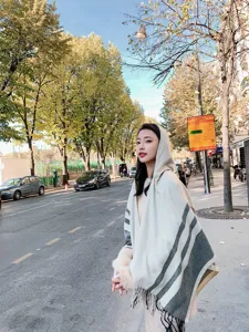 Stylish women's hooded tassel cape shawl, autumn winter warm striped design outdoor wear.