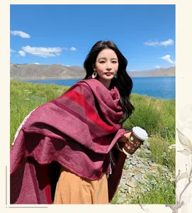 Outdoor travel detail of bohemian striped warm cashmere-feel cloak shawl worn by woman.