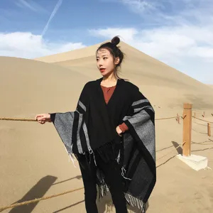 Detailed view of the women's hooded tassel cape, stylish winter warm shawl for daily wear.