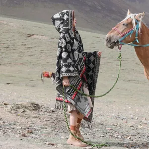 Ethnic style knitted hooded poncho cape detail view, fringe design for travel and autumn winter.