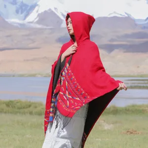 Ethnic style red hooded knit poncho detail, tassel fringe and geometric pattern cloak design.