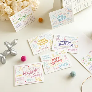 Detailed close-up of handwritten birthday greeting cards with cute artistic illustrations.