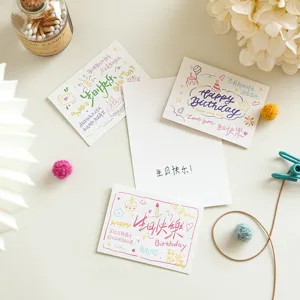 Detailed view of handwritten birthday greeting cards with cute doodles and warm wishes.