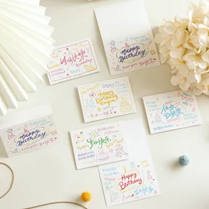Detailed view of handwritten birthday greeting cards with cute doodles and warm words.