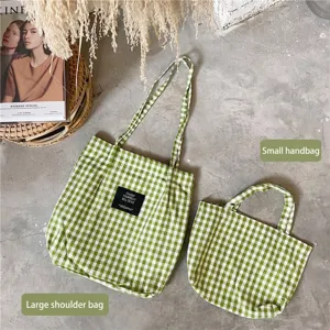 Detailed view comparing the large shoulder tote and small handbag in green gingham fabric