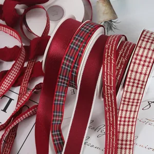 Close-up of burgundy plaid and textured ribbons for elegant festive gift packaging