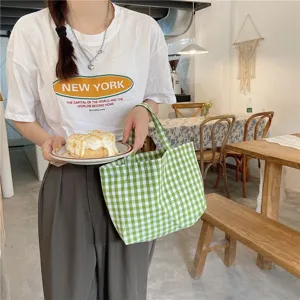 Detail shot of a Japanese style green gingham checkered portable lunch tote bag