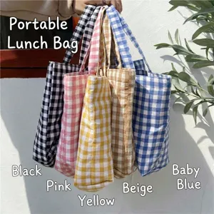 Close-up of colorful gingham lunch tote bags showing fabric texture and patterns