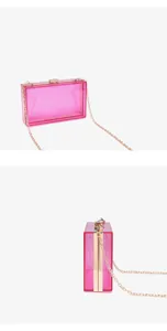 Detailed view of vibrant pink transparent acrylic box clutch with gold chain strap