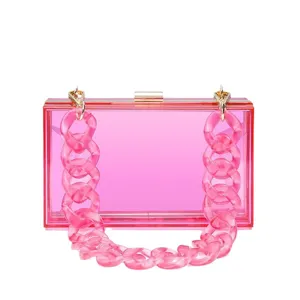 Stylish pink transparent acrylic evening clutch bag with a chunky resin chain strap.