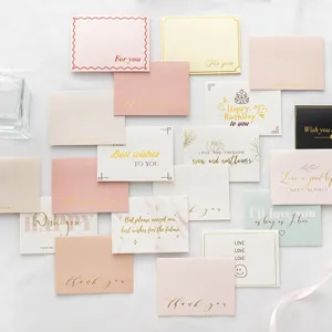 Assorted gold-stamped greeting cards, elegant gift message cards for florist and baking decor.