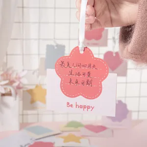 Primer plano detallado de una bonita tarjeta de felicitación rosa en forma de flor con cinta bonita.