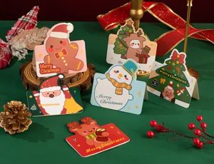 Bonito juego de tarjetas de felicitación navideñas con muñeco de jengibre y reno.