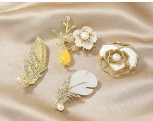 Detail view of exquisite floral and feather brooches with pearls and rhinestones.