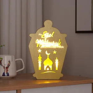 LED wooden decorative lamp detail shot, showing hollow castle pattern and warm night light glow.