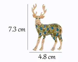 Gold tone deer brooch with blue enamel and green crystals, elegant animal fashion jewelry.