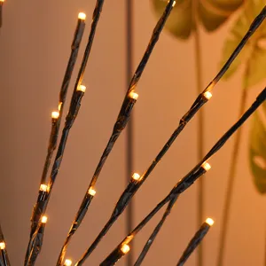Close-up detail shot of artificial LED branch light featuring warm glowing bulbs for cozy room decor.