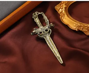 Detailed view of vintage sword brooch back, showing secure pin clasp and antique alloy finish.
