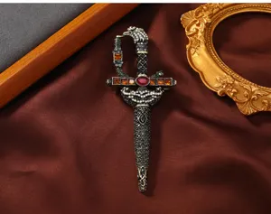Vintage sword brooch detail, exquisite multi-color rhinestones and retro metal craftsmanship.