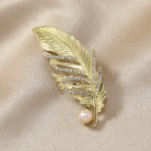 Gold feather brooch with sparkling crystals and pearl accent for stylish coat dress decoration