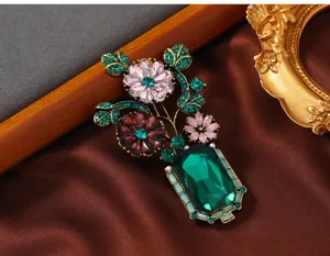 Vintage crystal flower vase brooch detailed view, elegant rhinestone decorative accessory.