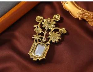 Detailed view of the vintage gold crystal vase brooch back design showing secure pin closure.