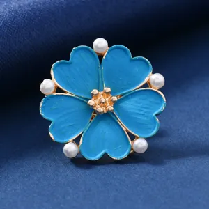 Vintage mini flower brooch with enamel and pearls, perfect detail view for elegant wear.