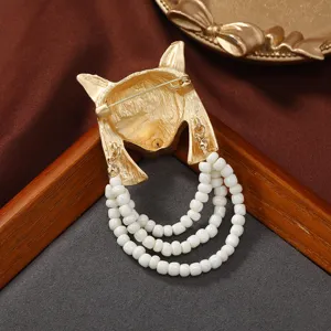 Exquisite vintage fox mask brooch detail, featuring elegant multi-layer pearl bead tassels.