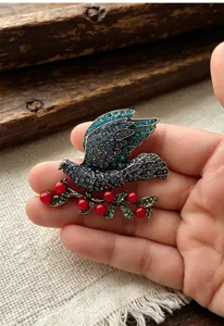 Vintage rhinestone peace dove brooch, detailed close-up shot of elegant animal coat pin.